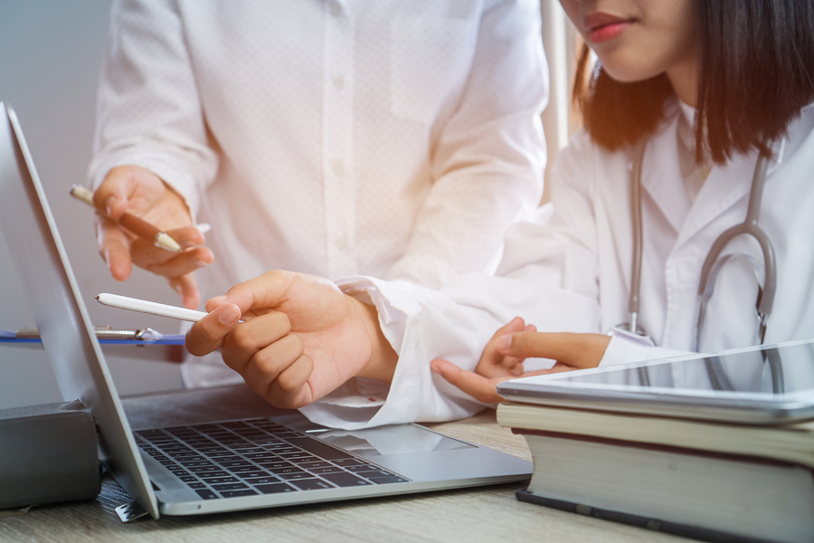 Medical professionals working with scanned images.