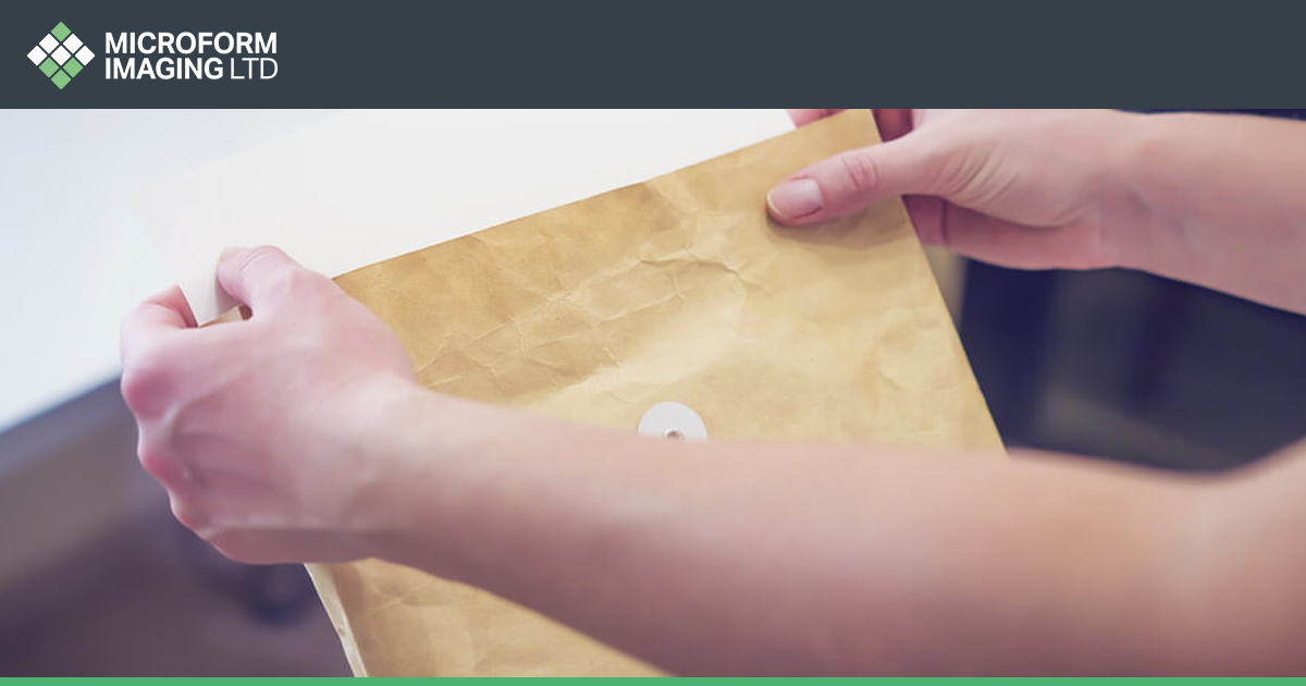 A person sorting mail in a digital mailroom.