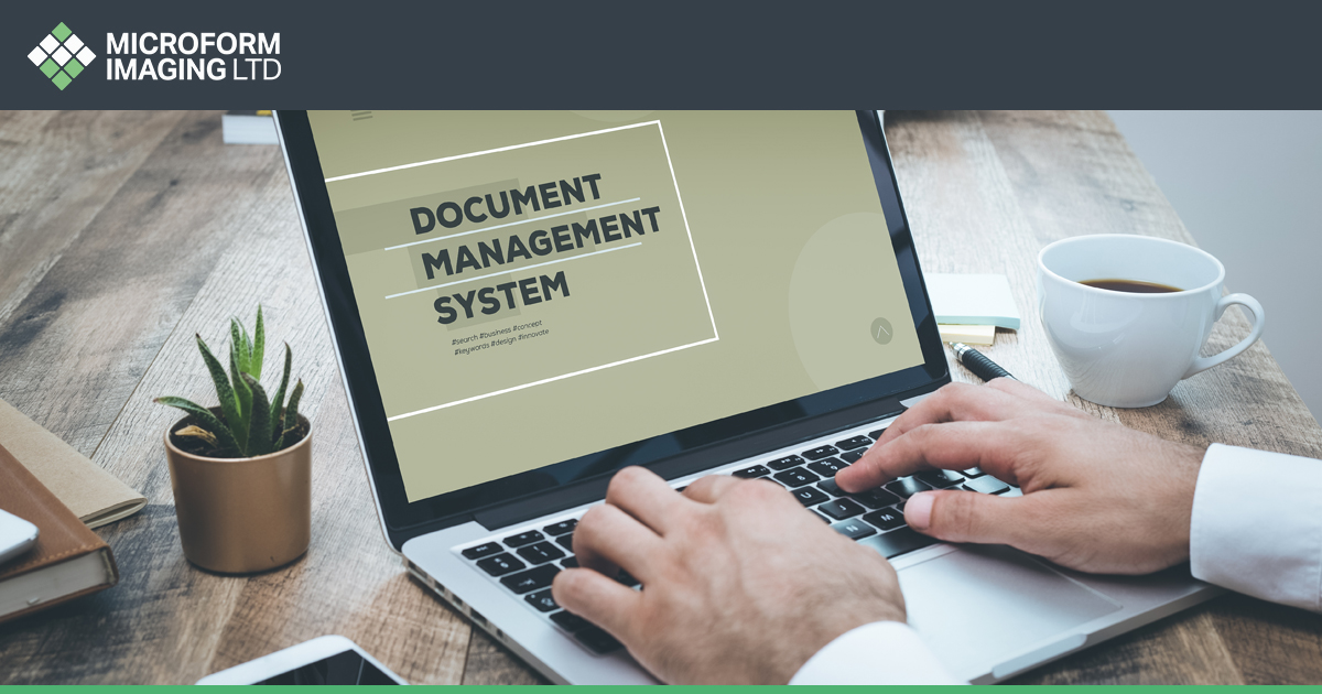 An office worker dealing with documents in an office without a document management system.