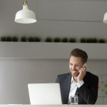 A picture of a man using a digital mailroom. He is happy.