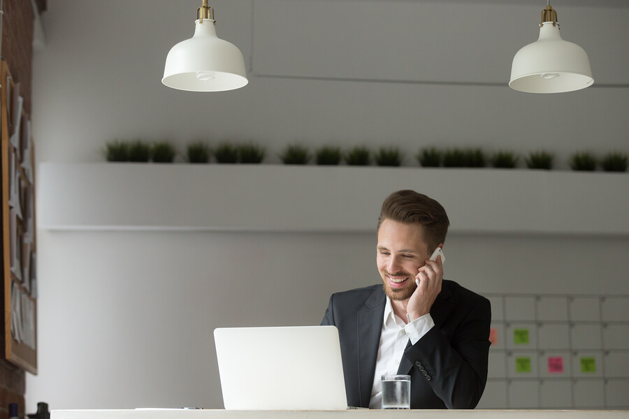A picture of a man using a digital mailroom. He is happy.
